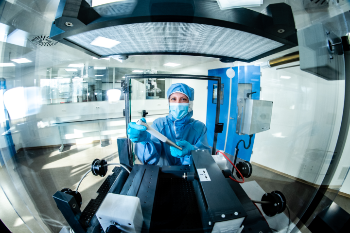 A scientist using an electrospinning machine.